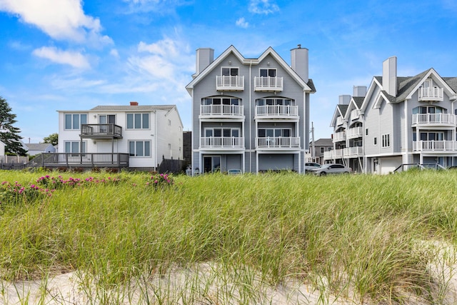 1 Saunders Ave Unit 12, Old Orchard Beach, ME 04064 - back of house featuring a balcony and a chimney