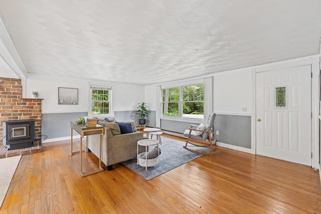 267 Manchester Rd, Standish, ME 04085 - living room featuring light wood-style floors and a wood stove