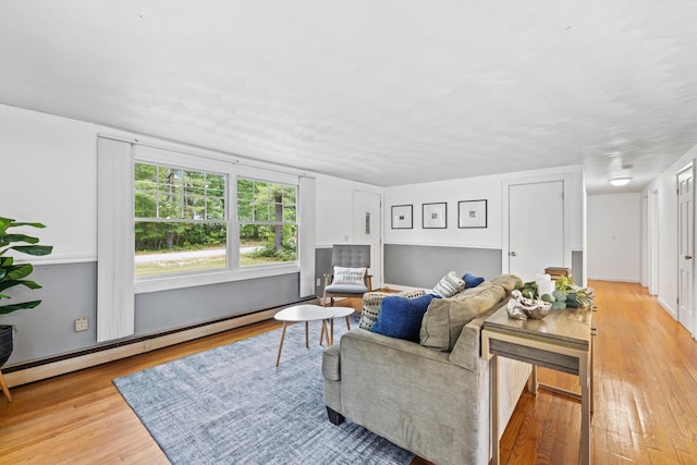 267 Manchester Rd, Standish, ME 04085 - living area with a baseboard radiator and light wood-style floors