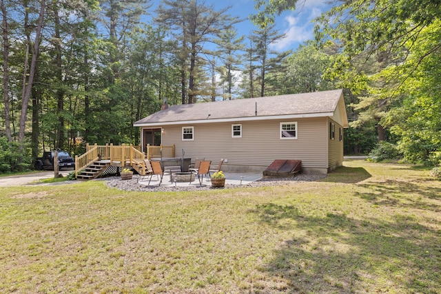 267 Manchester Rd, Standish, ME 04085 - rear view of house featuring a wooden deck, a yard, an outdoor fire pit, and a patio area
