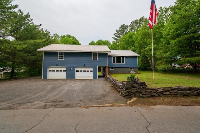 44 Donigan Rd, Moscow, ME 04920 - view of front of house featuring asphalt driveway, an attached garage, and a front lawn
