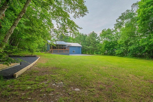 44 Donigan Rd, Moscow, ME 04920 - view of grassy yard with a deck and a view of trees