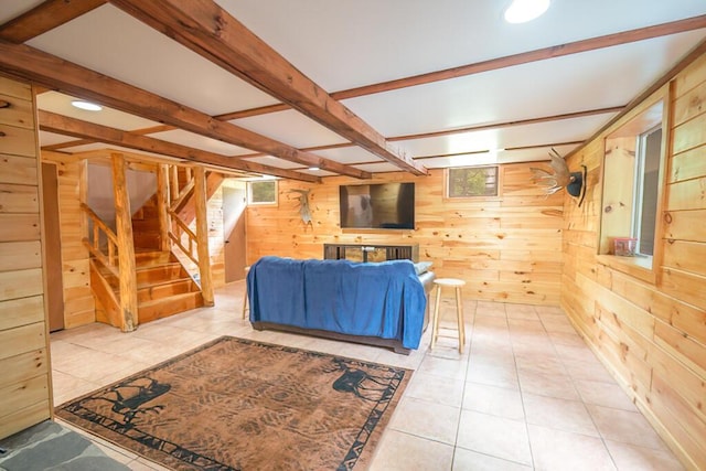 44 Donigan Rd, Moscow, ME 04920 - tiled living room featuring wood walls, stairs, and beam ceiling