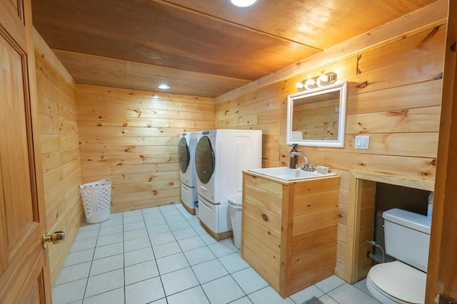 44 Donigan Rd, Moscow, ME 04920 - washroom featuring washer and clothes dryer, wood ceiling, light tile patterned floors, and wooden walls