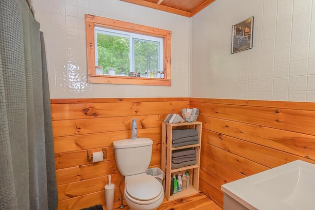 44 Donigan Rd, Moscow, ME 04920 - full bathroom featuring wooden walls and a shower with shower curtain
