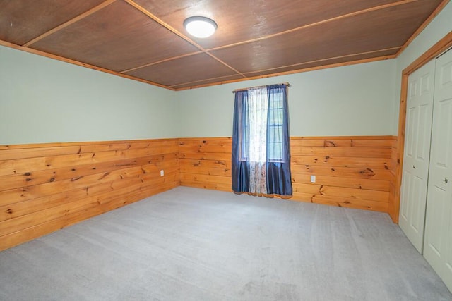 44 Donigan Rd, Moscow, ME 04920 - carpeted empty room with a wainscoted wall, wooden walls, and wooden ceiling