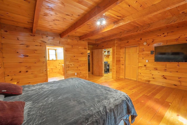 44 Donigan Rd, Moscow, ME 04920 - bedroom with wooden walls, hardwood / wood-style flooring, a wooden ceiling with exposed beams, and connected bathroom