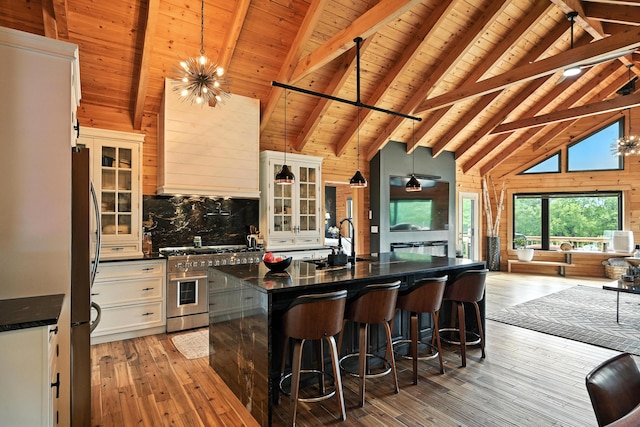 1277 Naples Rd, Harrison, ME 04040 - kitchen featuring stainless steel appliances, a wooden ceiling with exposed beams, light wood-style floors, tasteful backsplash, and glass insert cabinets