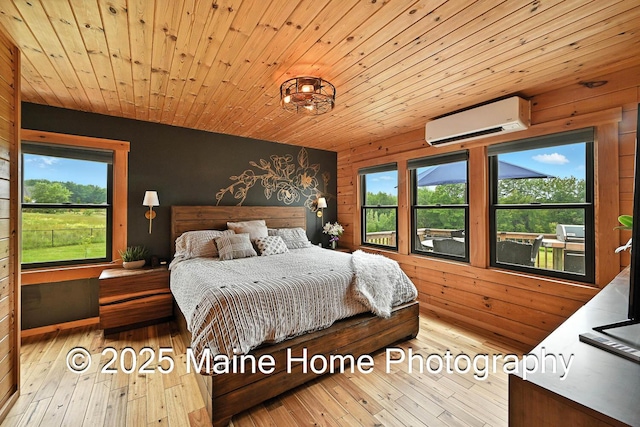 1277 Naples Rd, Harrison, ME 04040 - bedroom featuring a wall unit AC, multiple windows, wood-type flooring, wood ceiling, and wood walls