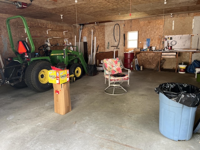 406 Cushman Rd, Winslow, ME 04901 - garage featuring a garage door opener and a workshop area