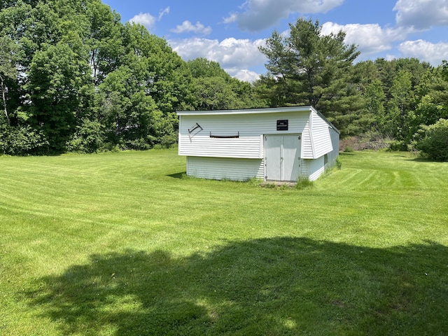 406 Cushman Rd, Winslow, ME 04901 - view of grassy yard featuring an outbuilding and a forest view