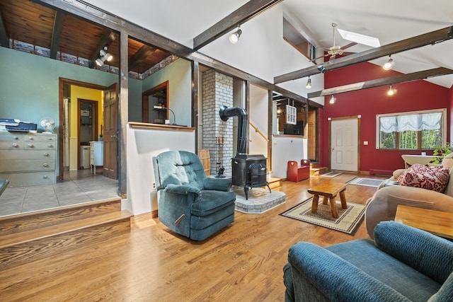 8 Holbrook Dr, Phippsburg, ME 04562 - living area featuring track lighting, a wood stove, wood finished floors, a ceiling fan, and a skylight