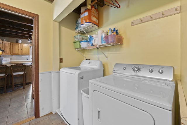 8 Holbrook Dr, Phippsburg, ME 04562 - washroom featuring separate washer and dryer, light tile patterned floors, and a wainscoted wall