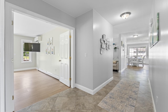 96 Frost Hill Ave, Lisbon, ME 04252 - corridor with baseboard heating, an AC wall unit, and tile patterned floors