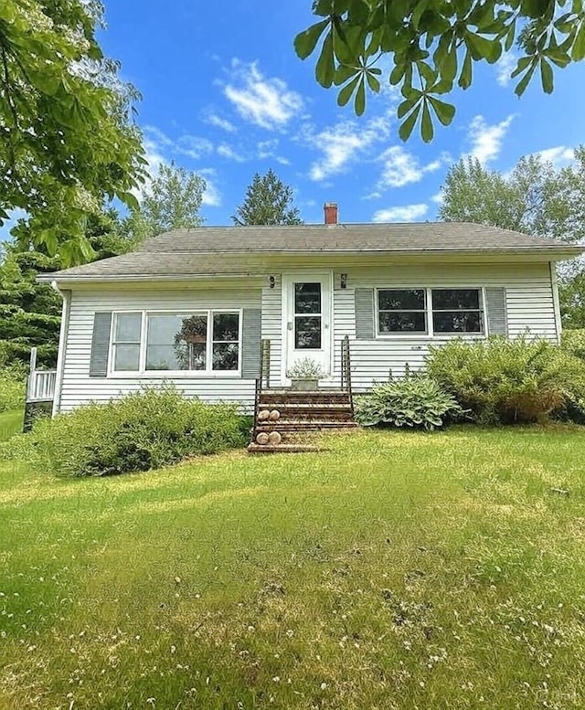 1190 Indian River Rd, Addison, ME 04606 - view of front of house with a front yard, a chimney, and entry steps