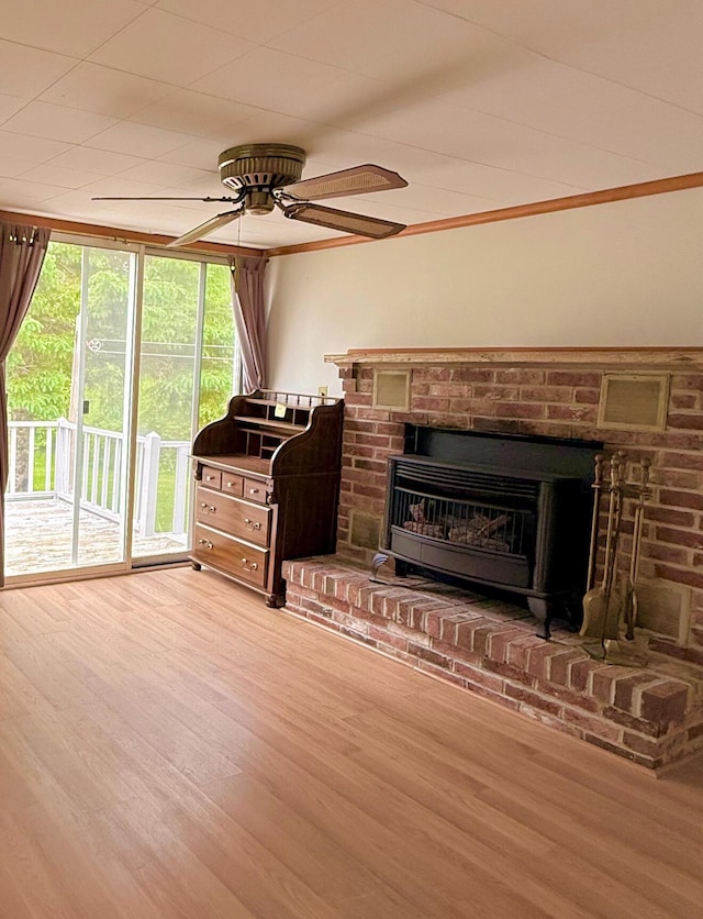 1190 Indian River Rd, Addison, ME 04606 - living area featuring a ceiling fan, wood finished floors, and a fireplace