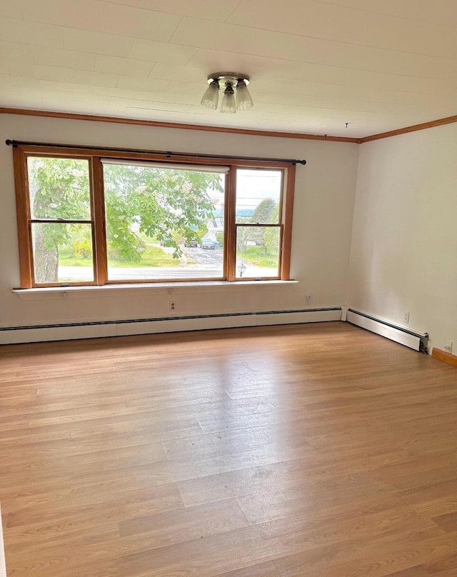 1190 Indian River Rd, Addison, ME 04606 - spare room with ornamental molding, light wood-style flooring, and a baseboard heating unit