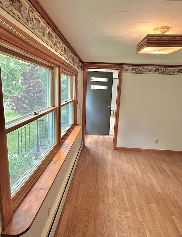 1190 Indian River Rd, Addison, ME 04606 - corridor with light wood finished floors and a baseboard heating unit