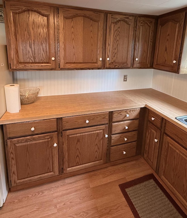 1190 Indian River Rd, Addison, ME 04606 - kitchen featuring light wood finished floors, light countertops, and brown cabinetry
