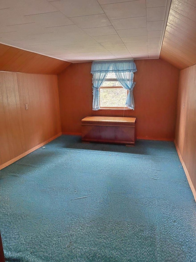 1190 Indian River Rd, Addison, ME 04606 - bonus room featuring wooden walls, vaulted ceiling, and carpet