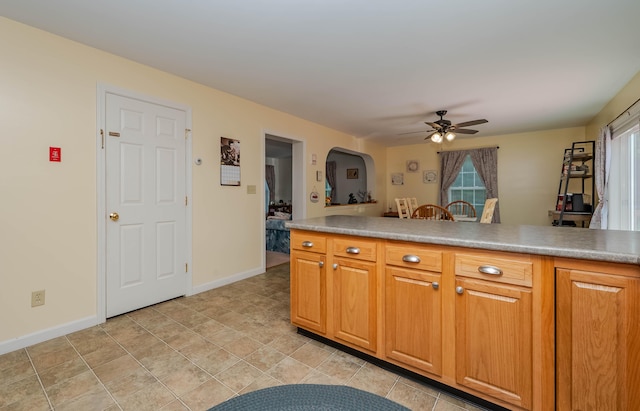 119 Somersworth Rd, North Berwick, ME 03906 - kitchen with a ceiling fan, arched walkways, and brown cabinetry