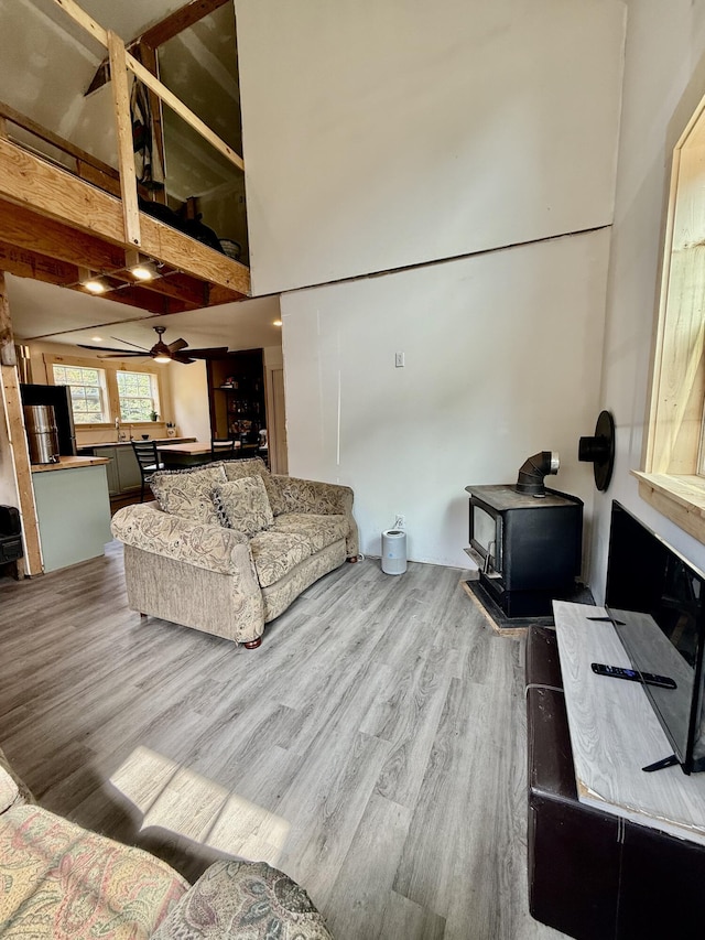 110 Cushing Rd, Friendship, ME 04547 - living area with a wood stove, wood finished floors, and ceiling fan