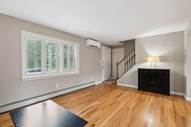 11 Concord Pl Unit 21, Auburn, ME 04210 - entryway featuring a baseboard heating unit, an AC wall unit, light wood-type flooring, and stairway
