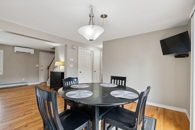 11 Concord Pl Unit 21, Auburn, ME 04210 - dining space with a wall mounted air conditioner, a baseboard radiator, stairs, and light wood-type flooring