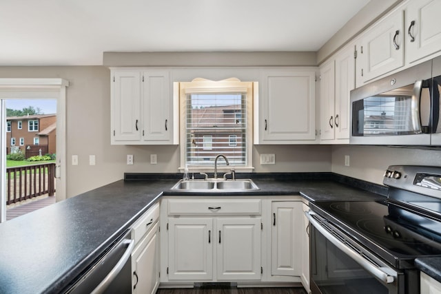 11 Concord Pl Unit 21, Auburn, ME 04210 - kitchen featuring stainless steel appliances, white cabinets, and dark countertops