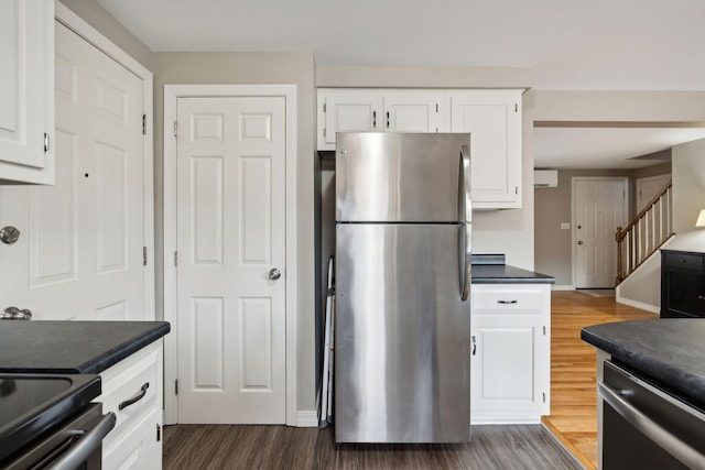 11 Concord Pl Unit 21, Auburn, ME 04210 - kitchen featuring appliances with stainless steel finishes, dark wood finished floors, dark countertops, and white cabinetry