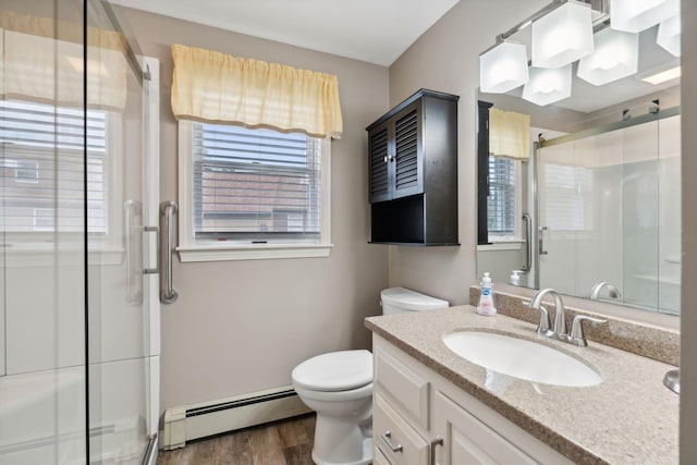 11 Concord Pl Unit 21, Auburn, ME 04210 - bathroom featuring baseboard heating, vanity, a shower stall, and plenty of natural light
