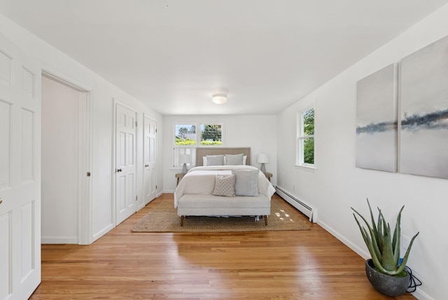 3 Tidewater Cv, Falmouth, ME 04105 - bedroom with a baseboard radiator, multiple windows, and light wood-style floors