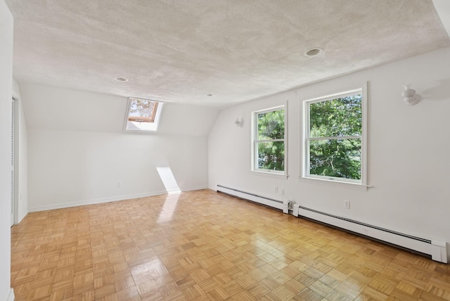 3 Tidewater Cv, Falmouth, ME 04105 - bonus room featuring a skylight, lofted ceiling, a textured ceiling, and baseboard heating