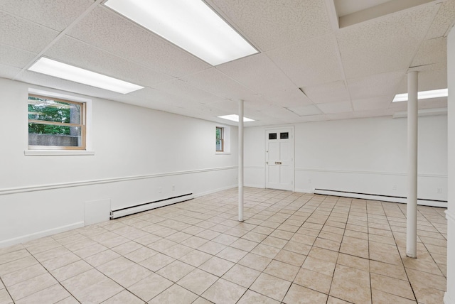 3 Tidewater Cv, Falmouth, ME 04105 - below grade area featuring baseboard heating, a paneled ceiling, a baseboard radiator, and light tile patterned floors
