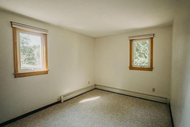 41 Curtis Ln, Milford, ME 04461 - empty room featuring carpet and a baseboard heating unit