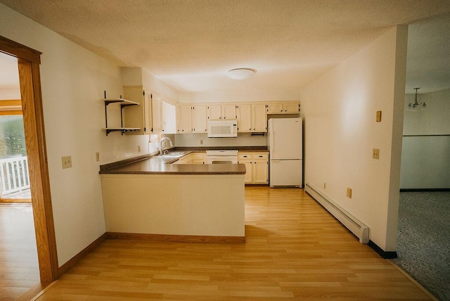 41 Curtis Ln, Milford, ME 04461 - kitchen with white appliances, a baseboard heating unit, light wood-style floors, and dark countertops