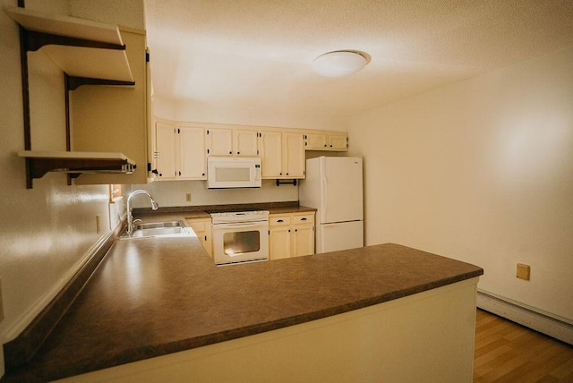 41 Curtis Ln, Milford, ME 04461 - kitchen with white appliances, a peninsula, a baseboard heating unit, wood finished floors, and dark countertops