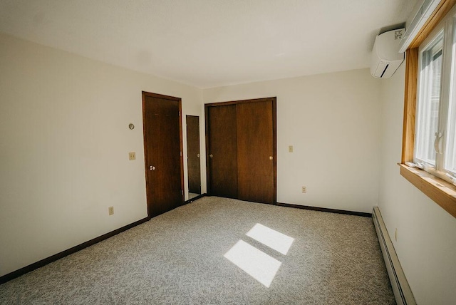 41 Curtis Ln, Milford, ME 04461 - carpeted empty room featuring a baseboard heating unit, an AC wall unit, and plenty of natural light
