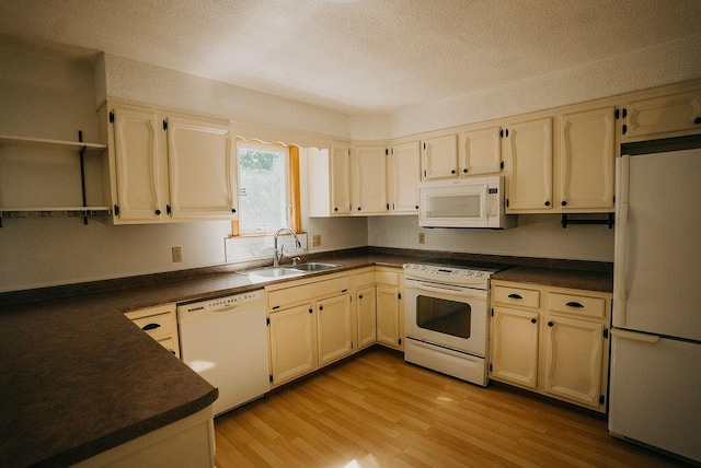 41 Curtis Ln, Milford, ME 04461 - kitchen with white appliances, dark countertops, light wood-style floors, a textured ceiling, and open shelves