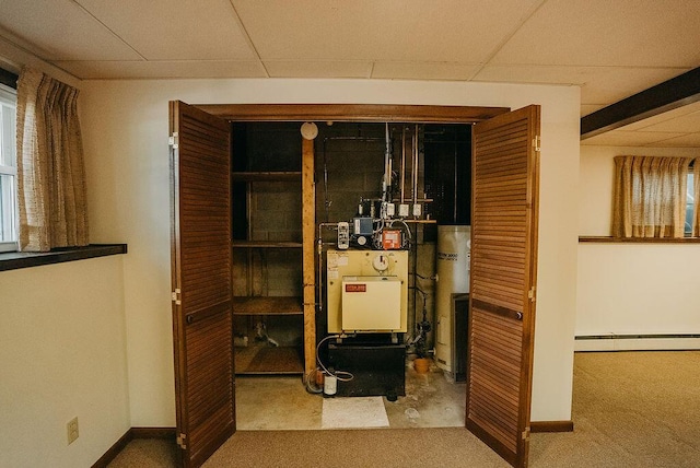 41 Curtis Ln, Milford, ME 04461 - utility room featuring baseboard heating and gas water heater