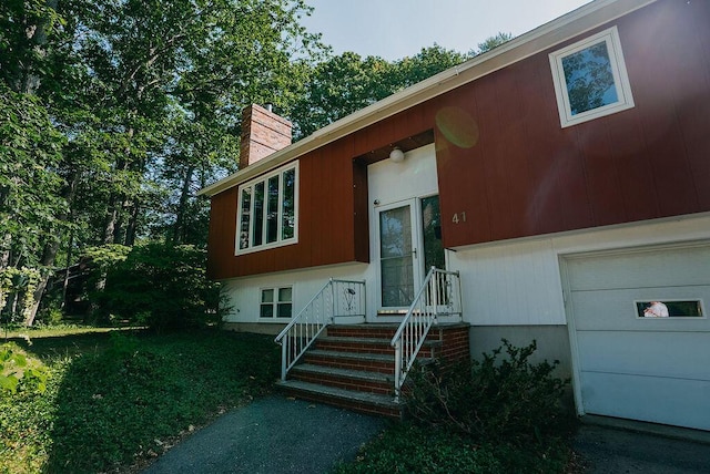 41 Curtis Ln, Milford, ME 04461 - property entrance featuring a chimney