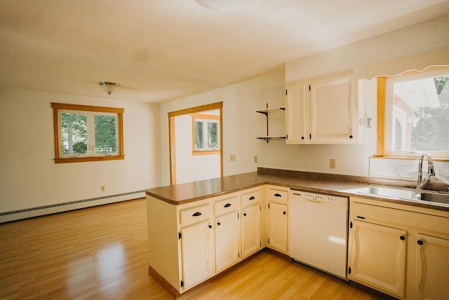 41 Curtis Ln, Milford, ME 04461 - kitchen featuring white dishwasher, light wood-style flooring, a baseboard heating unit, and healthy amount of natural light