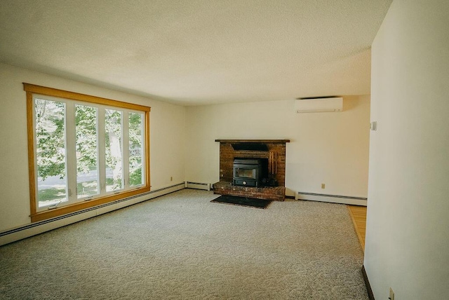41 Curtis Ln, Milford, ME 04461 - unfurnished living room featuring a wall mounted air conditioner, a baseboard radiator, a textured ceiling, and carpet flooring