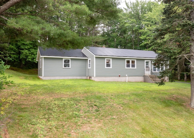 919 College St, Lewiston, ME 04240 - rear view of house featuring a metal roof and a lawn