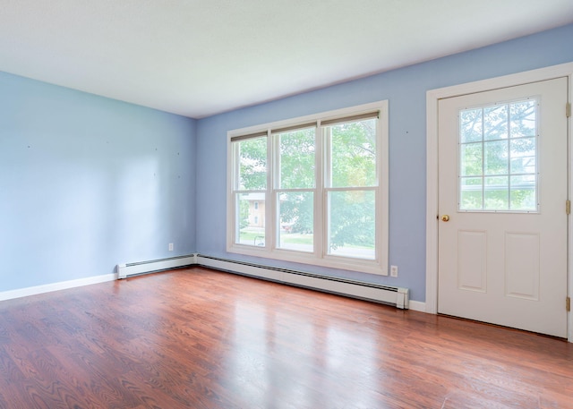 919 College St, Lewiston, ME 04240 - foyer with wood finished floors and a baseboard heating unit