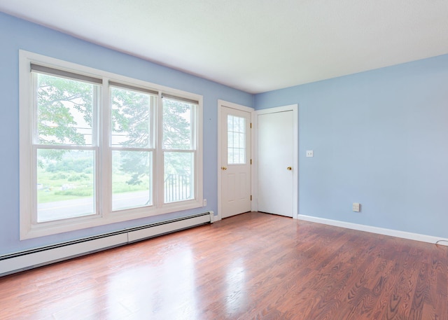 919 College St, Lewiston, ME 04240 - spare room with a baseboard radiator, plenty of natural light, and wood finished floors