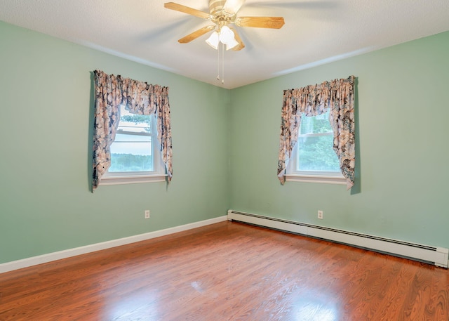 919 College St, Lewiston, ME 04240 - empty room featuring a baseboard heating unit, wood finished floors, and a ceiling fan