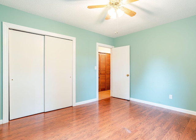 919 College St, Lewiston, ME 04240 - unfurnished bedroom featuring wood finished floors, a closet, and a ceiling fan