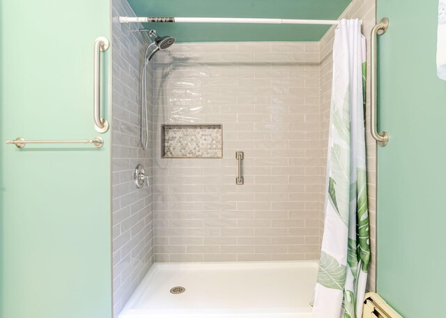 919 College St, Lewiston, ME 04240 - bathroom with a shower with curtain and a baseboard heating unit