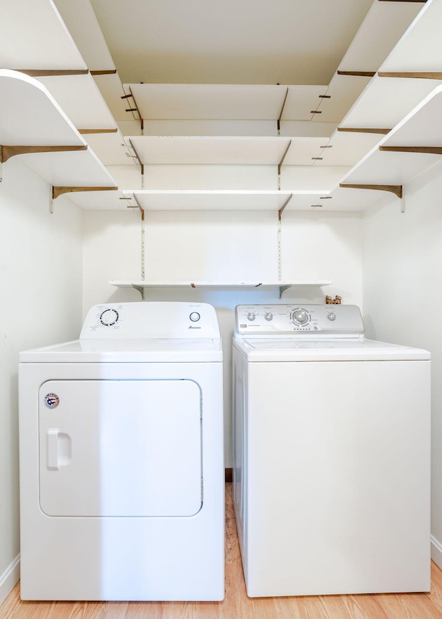 919 College St, Lewiston, ME 04240 - laundry room featuring separate washer and dryer and light wood-style floors